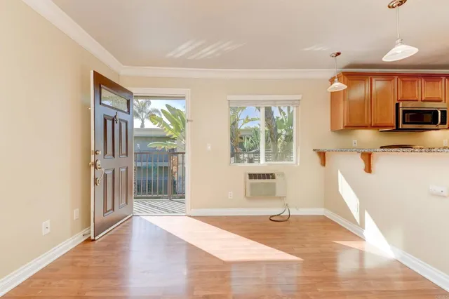 a living room with stainless steel appliances kitchen island granite countertop a refrigerator stove top oven and sink