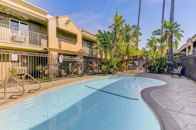 a view of a basket ball ground with palm trees