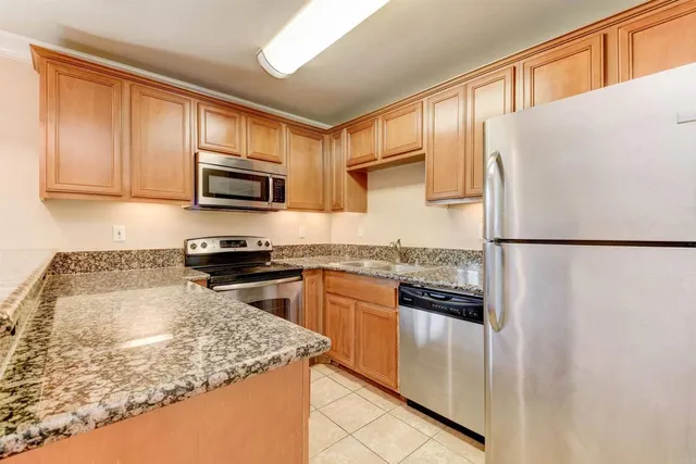 a kitchen with a refrigerator sink and microwave