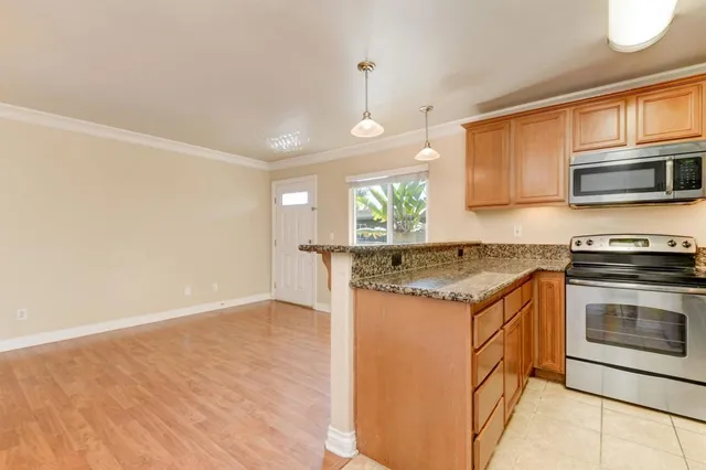 a kitchen with granite countertop a stove and a sink