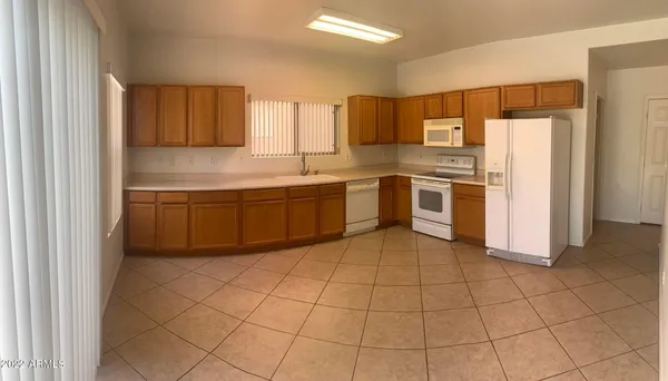 a kitchen with stainless steel appliances granite countertop a stove a refrigerator and a sink