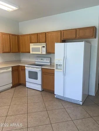 a kitchen with a sink a stove and cabinets