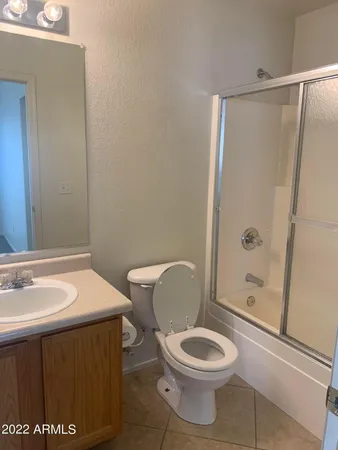 a bathroom with a toilet a sink and shower