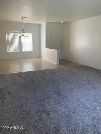an empty room with windows and fireplace