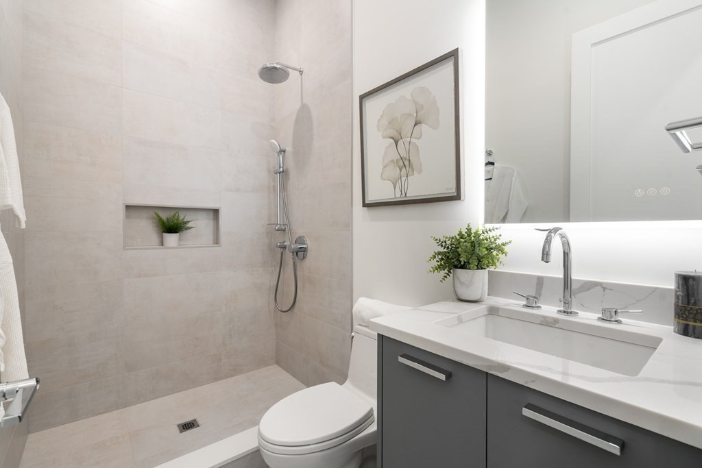 55 Rosalie Road Newton, MA 02459 - Photo 16 of 42 a bathroom with a sink a toilet and shower