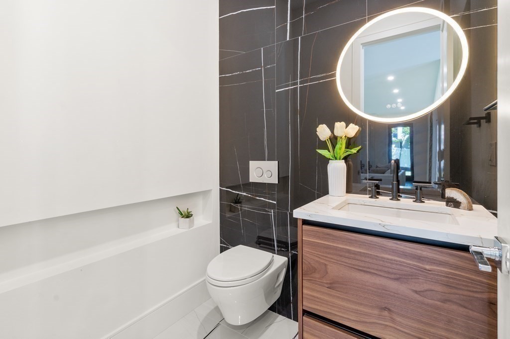 55 Rosalie Road Newton, MA 02459 - Photo 17 of 42 a bathroom with a sink mirror vanity and toilet