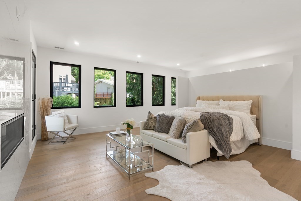 55 Rosalie Road Newton, MA 02459 - Photo 21 of 42 a spacious bedroom with a bed couch and large windows