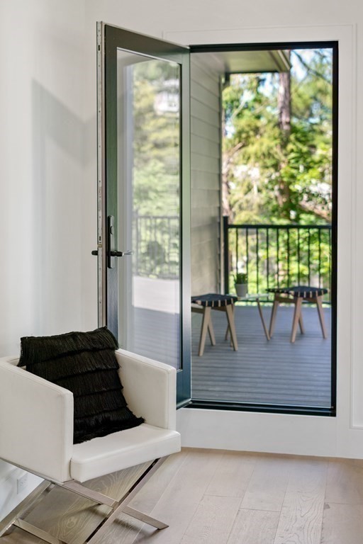 55 Rosalie Road Newton, MA 02459 - Photo 22 of 42 a living room with a couch and floor to ceiling window