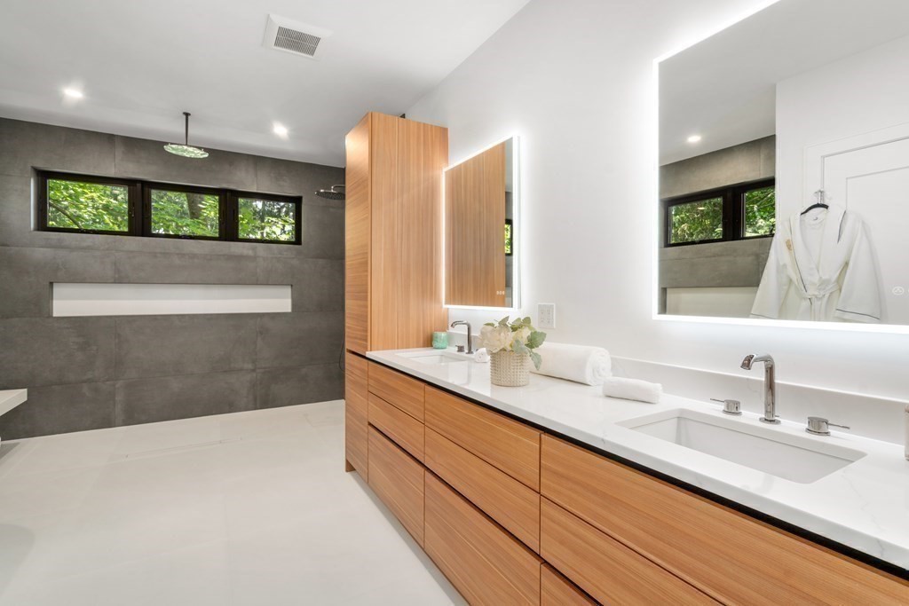 55 Rosalie Road Newton, MA 02459 - Photo 24 of 42 a bathroom with a double vanity sink and a mirror