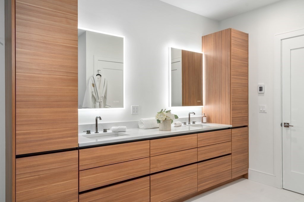 55 Rosalie Road Newton, MA 02459 - Photo 27 of 42 a bathroom with a double vanity sink and mirror