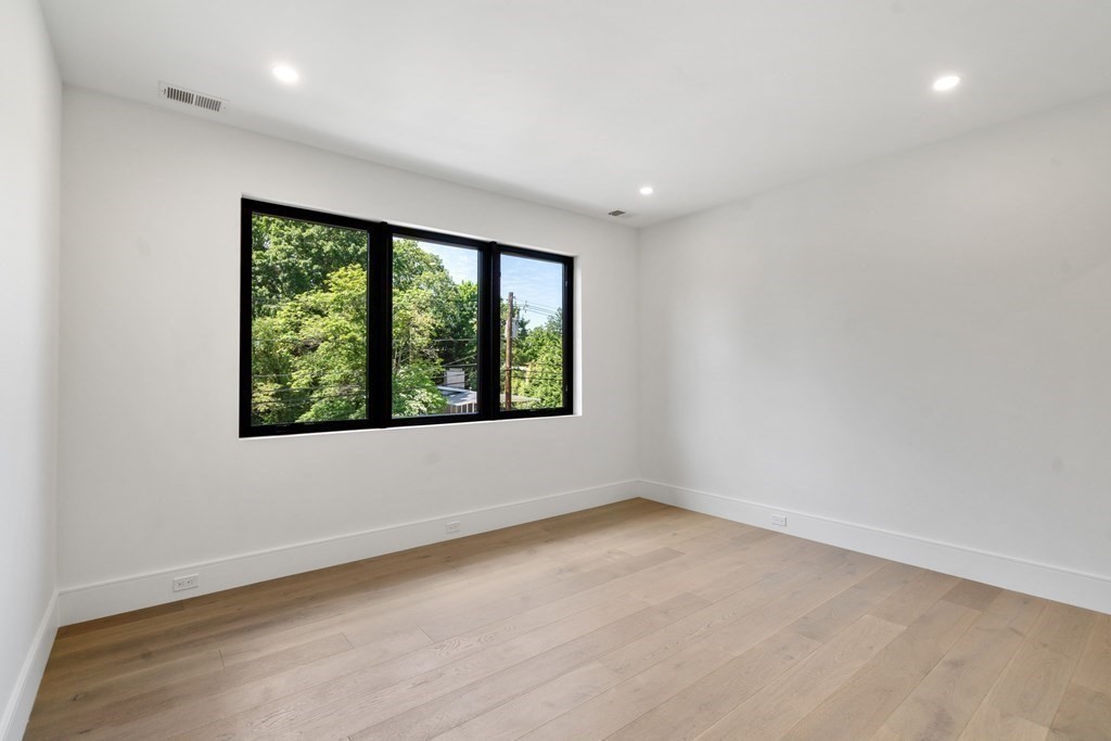 55 Rosalie Road Newton, MA 02459 - Photo 32 of 42 wooden floor in an empty room with a window