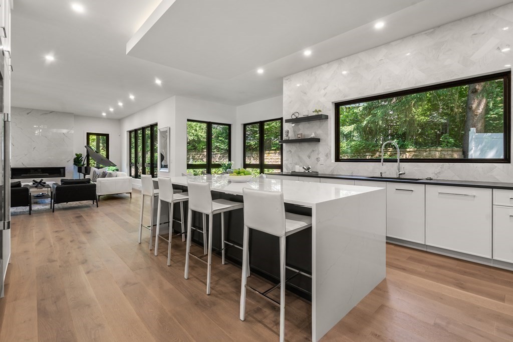 55 Rosalie Road Newton, MA 02459 - Photo 5 of 42 a large kitchen with lots of furniture a sink dining table and chairs