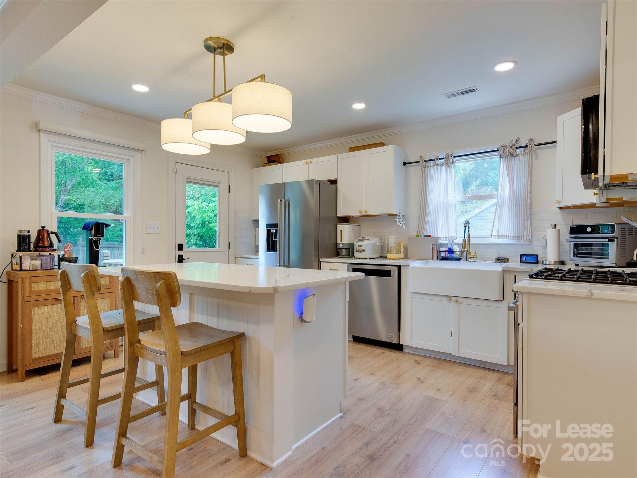 619 Fence Post Lane Matthews, NC 28105 - Photo 12 of 47 a kitchen with cabinets a center island and appliances