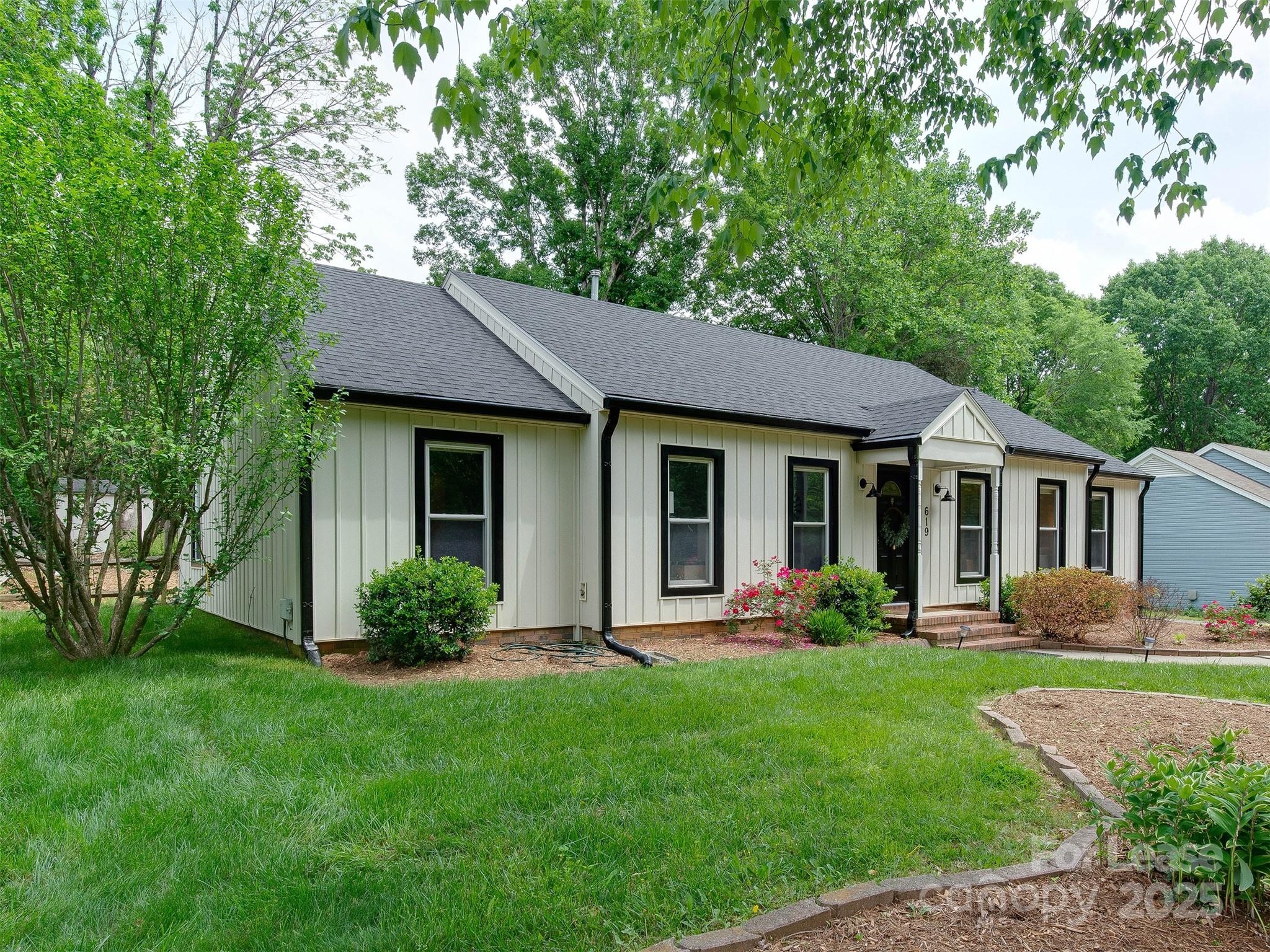 619 Fence Post Lane Matthews, NC 28105 - Photo 2 of 47 a view of a house with a yard and plants