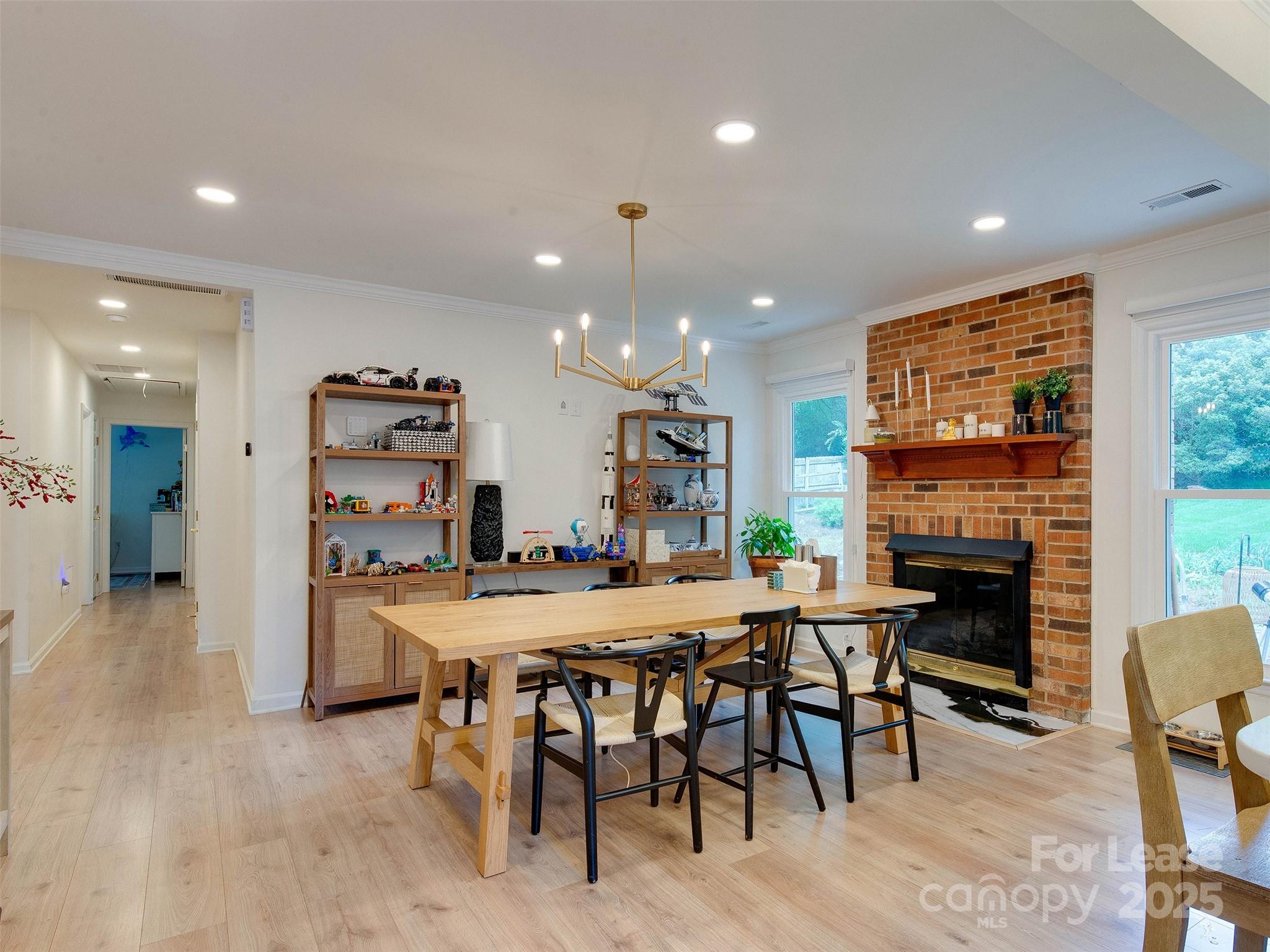 619 Fence Post Lane Matthews, NC 28105 - Photo 22 of 47 a dining room with furniture a fireplace and a kitchen view