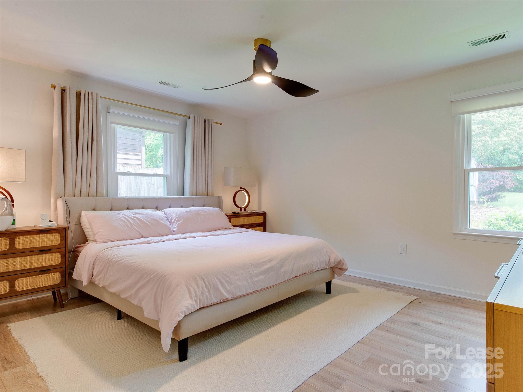 619 Fence Post Lane Matthews, NC 28105 - Photo 29 of 47 a bedroom with a bed chandelier and a window