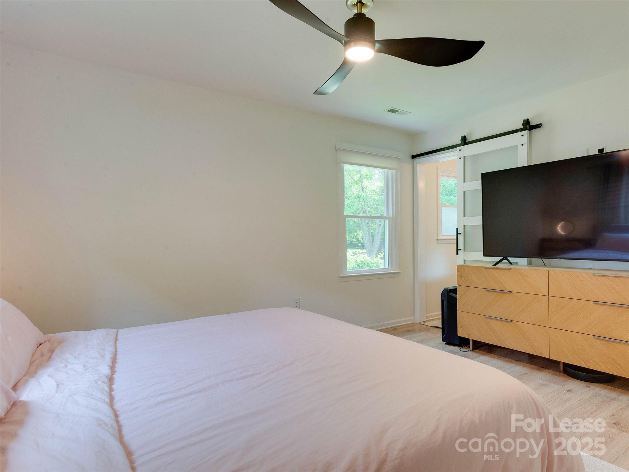 619 Fence Post Lane Matthews, NC 28105 - Photo 30 of 47 a bedroom with a bed and a flat screen tv