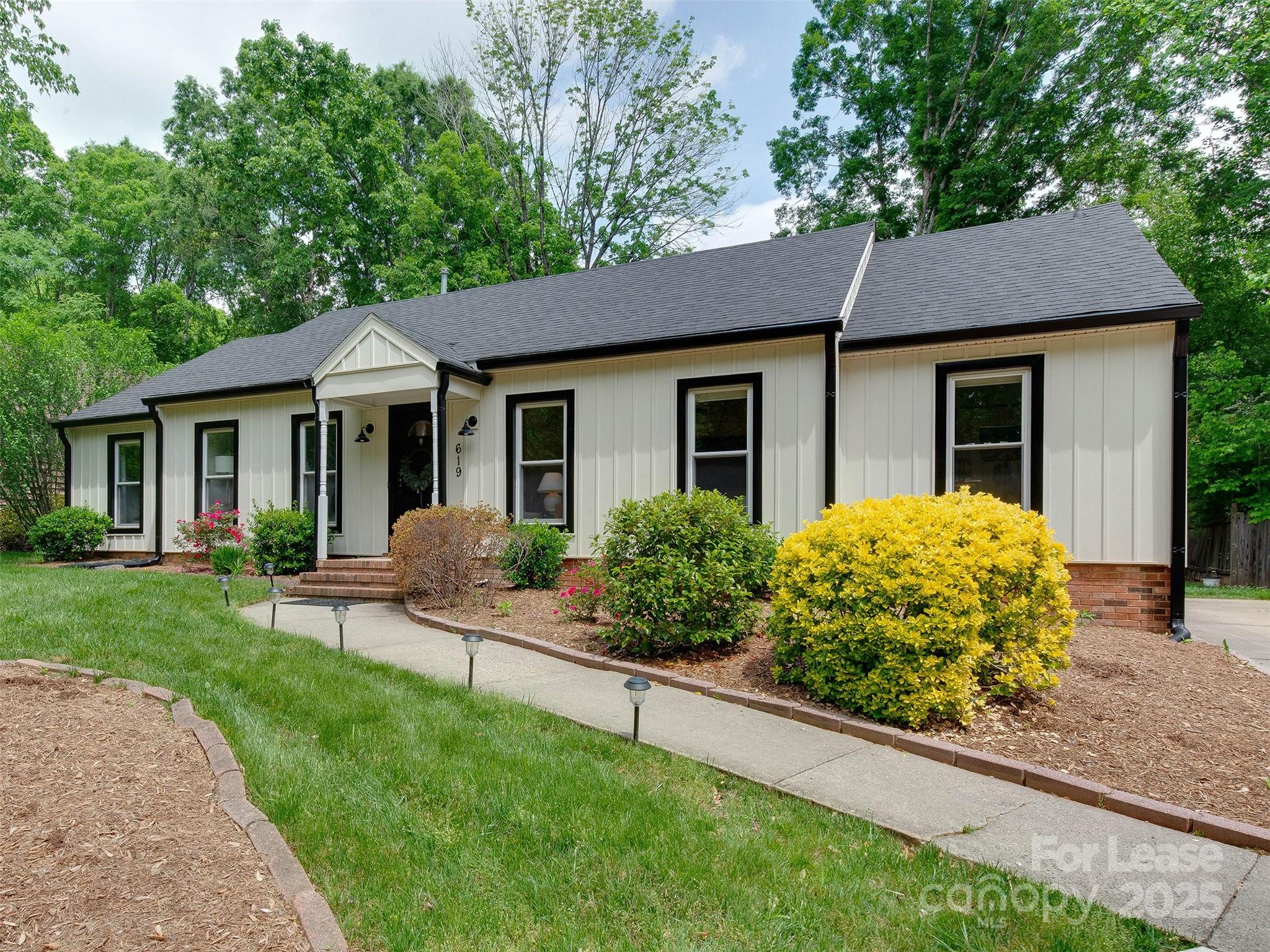 619 Fence Post Lane Matthews, NC 28105 - Photo 3 of 47 a view of a house with a yard and large tree