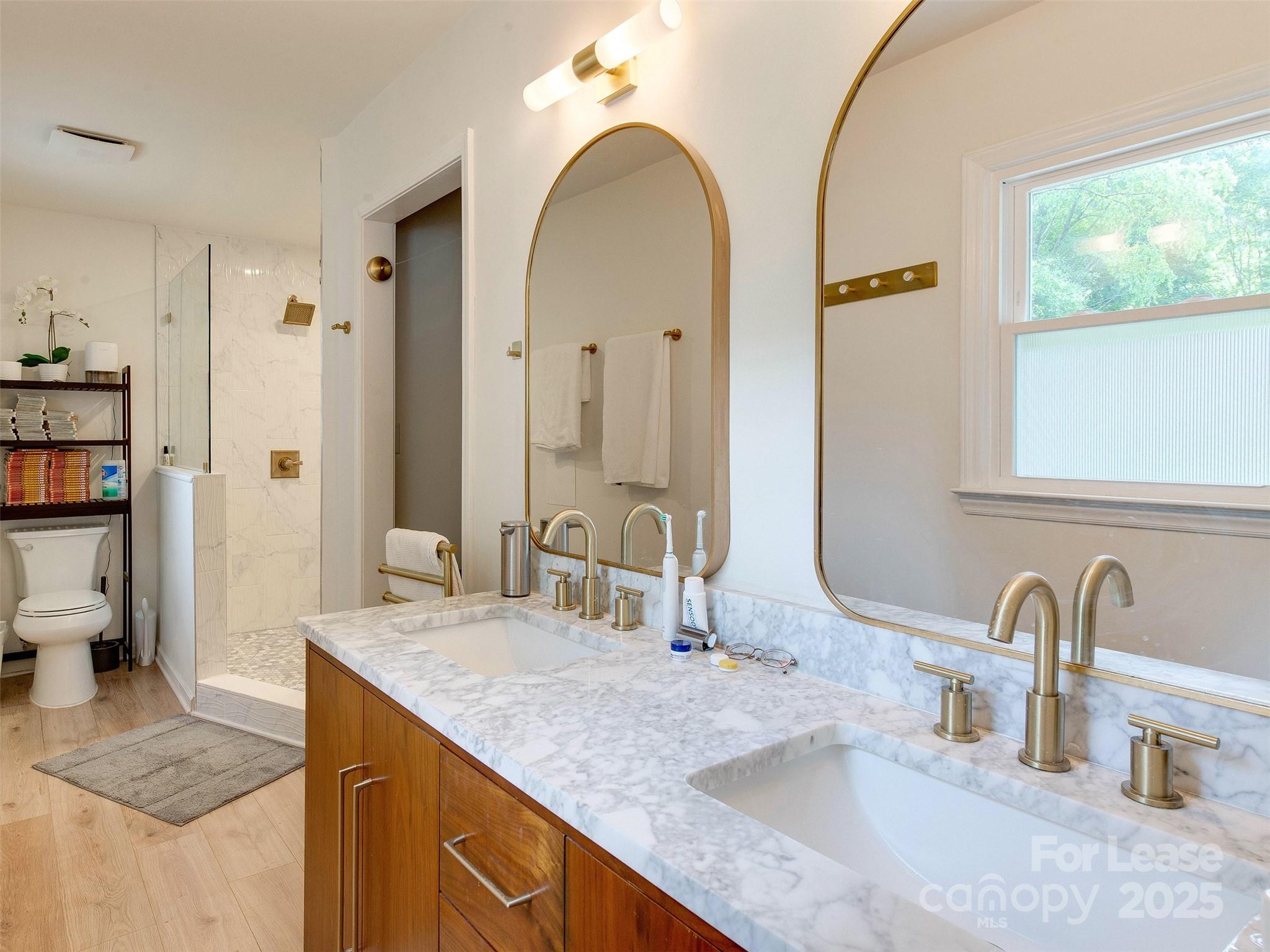 619 Fence Post Lane Matthews, NC 28105 - Photo 32 of 47 a bathroom with a granite countertop sink a large mirror and a shower