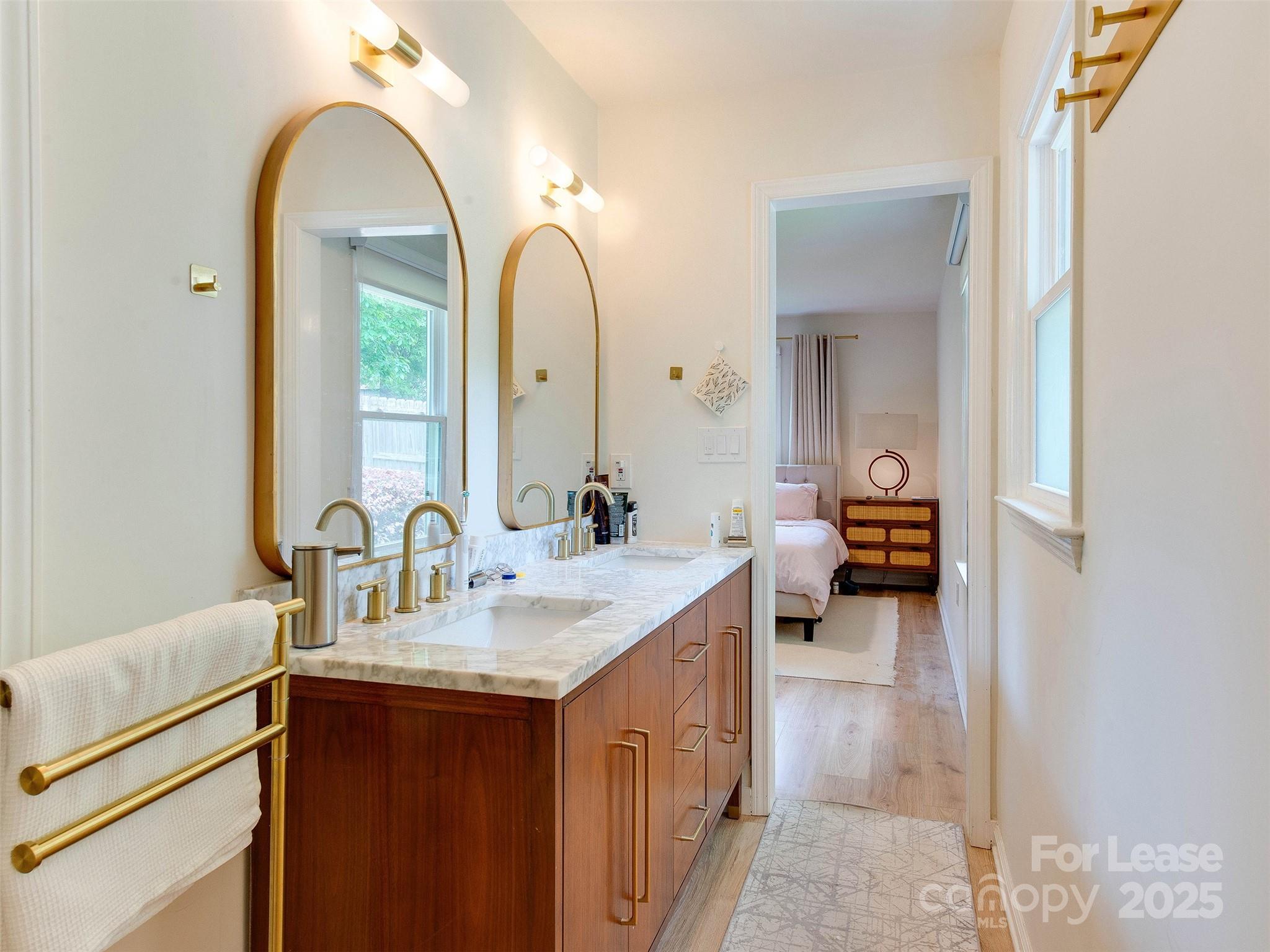 619 Fence Post Lane Matthews, NC 28105 - Photo 33 of 47 a en suite bathroom with a double vanity sink a mirror and a