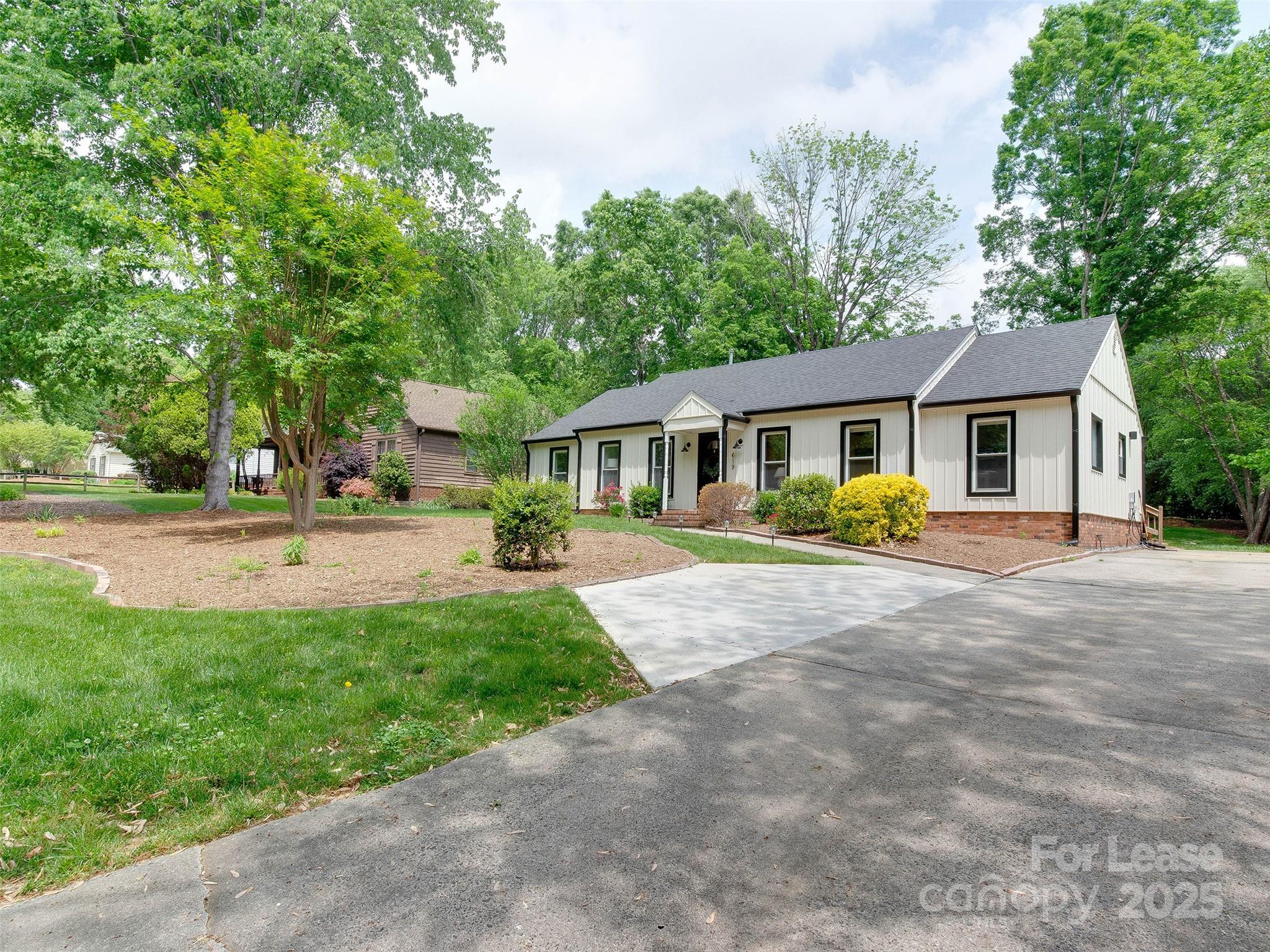 619 Fence Post Lane Matthews, NC 28105 - Photo 45 of 47 a front view of a house with a yard and trees