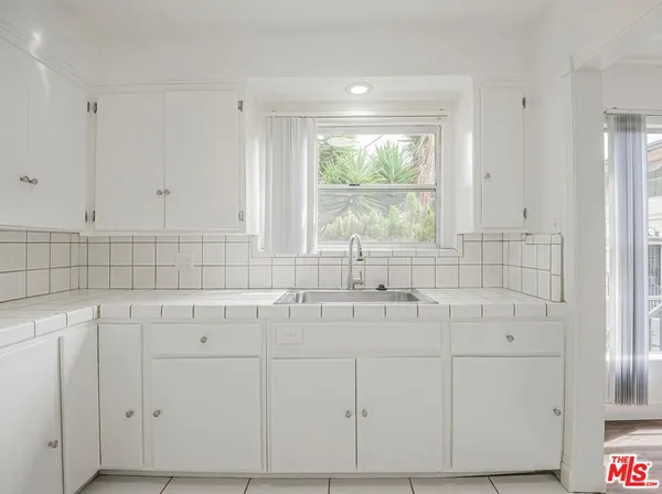 a bathroom with a sink and a window