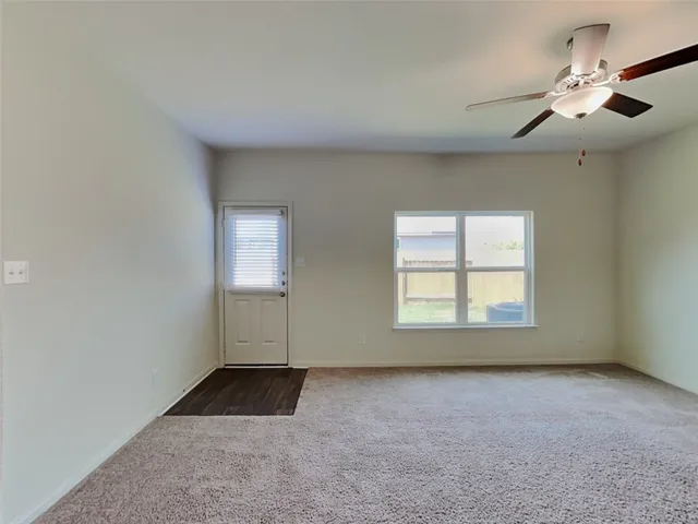 an empty room with a empty space and windows