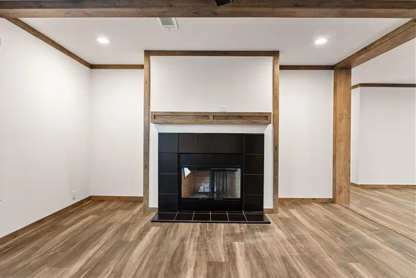 a room with fireplace and a wooden floor