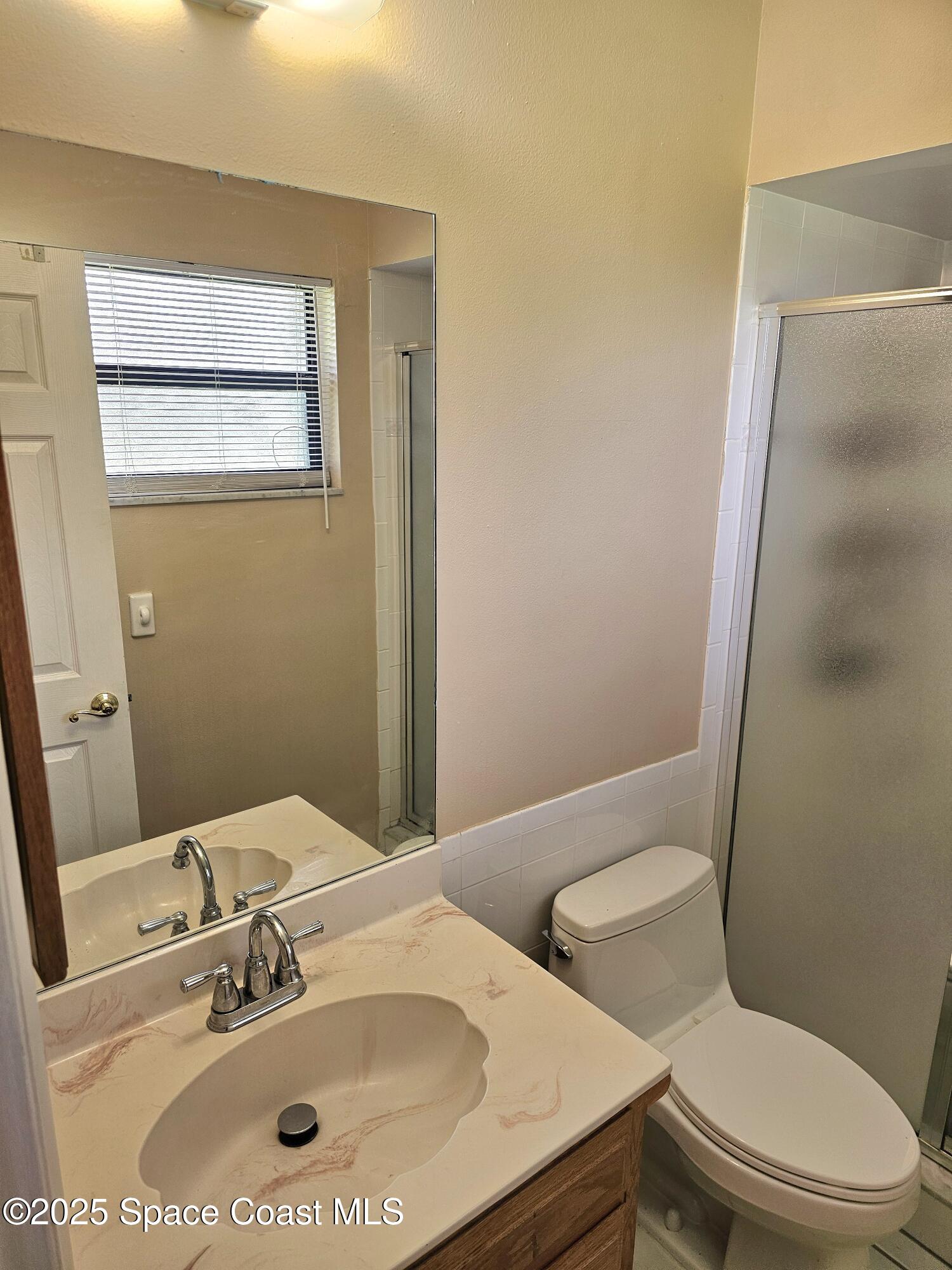 898 Hampton Drive Northeast Palm Bay, FL 32905 - Photo 11 of 20 a bathroom with a sink and a mirror