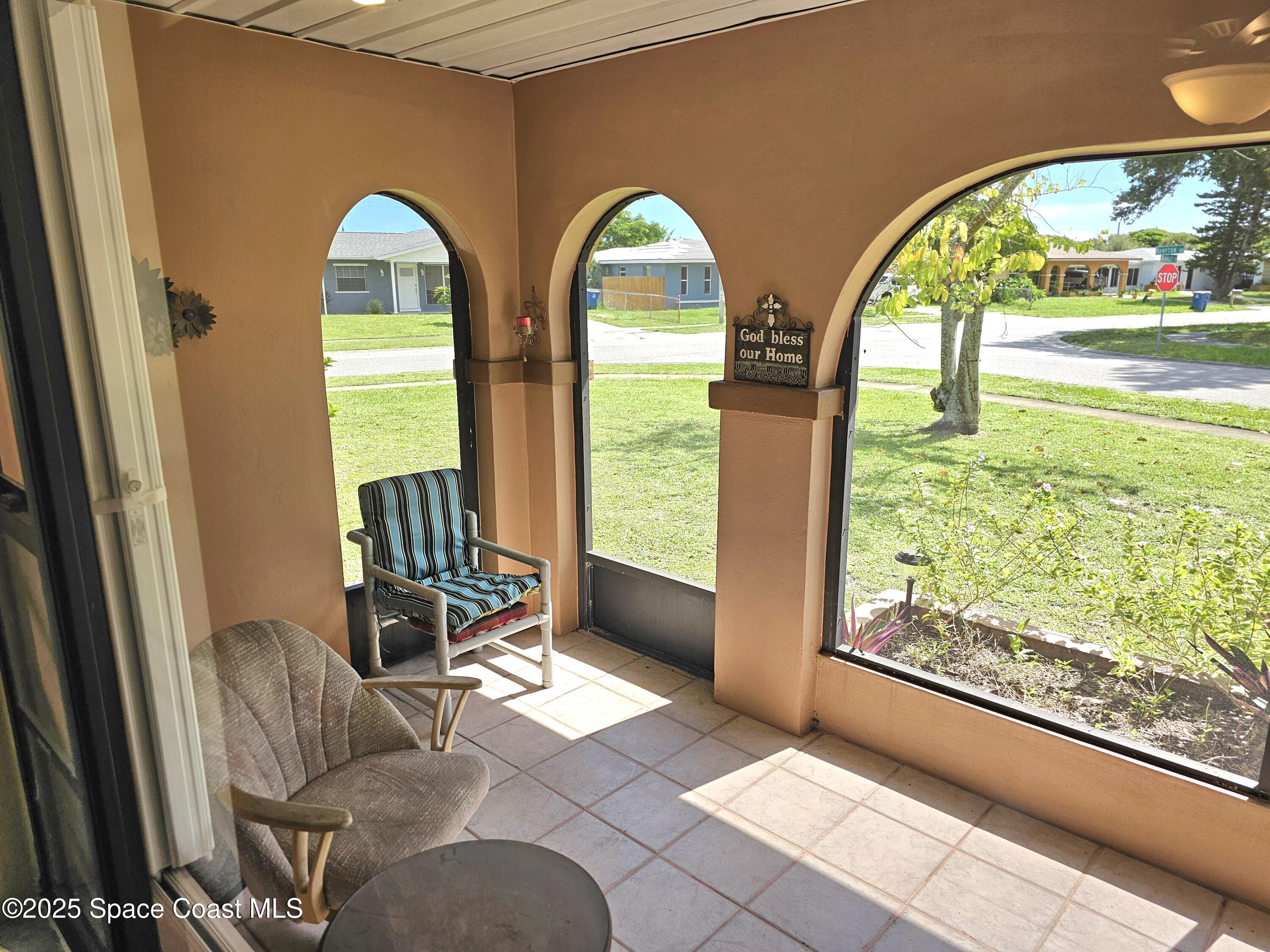 898 Hampton Drive Northeast Palm Bay, FL 32905 - Photo 17 of 20 a view of living room with large windows and a outdoor space
