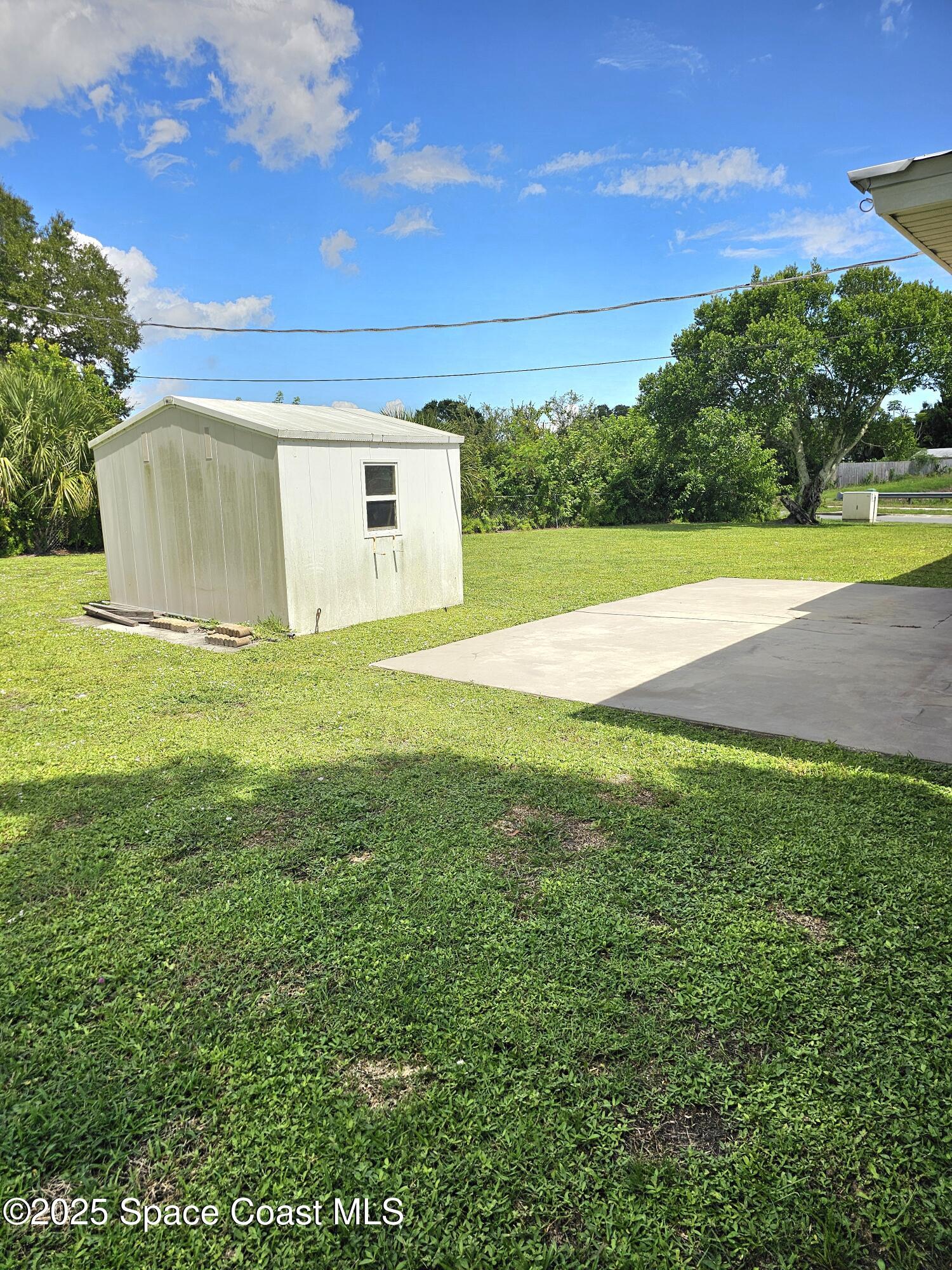 898 Hampton Drive Northeast Palm Bay, FL 32905 - Photo 19 of 20 a view of a big yard with a house