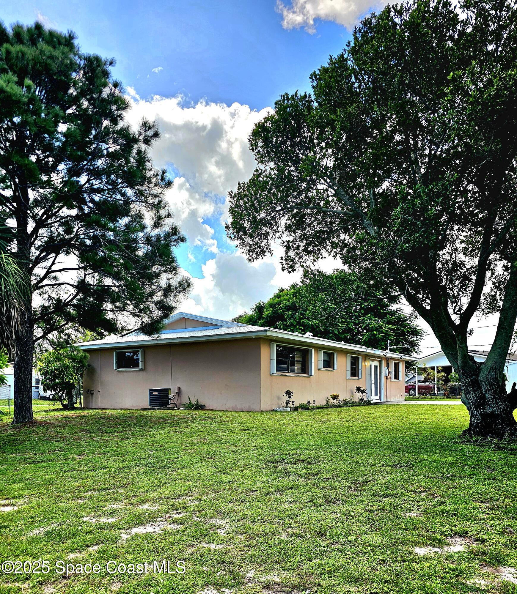 898 Hampton Drive Northeast Palm Bay, FL 32905 - Photo 20 of 20 a front view of house with a garden