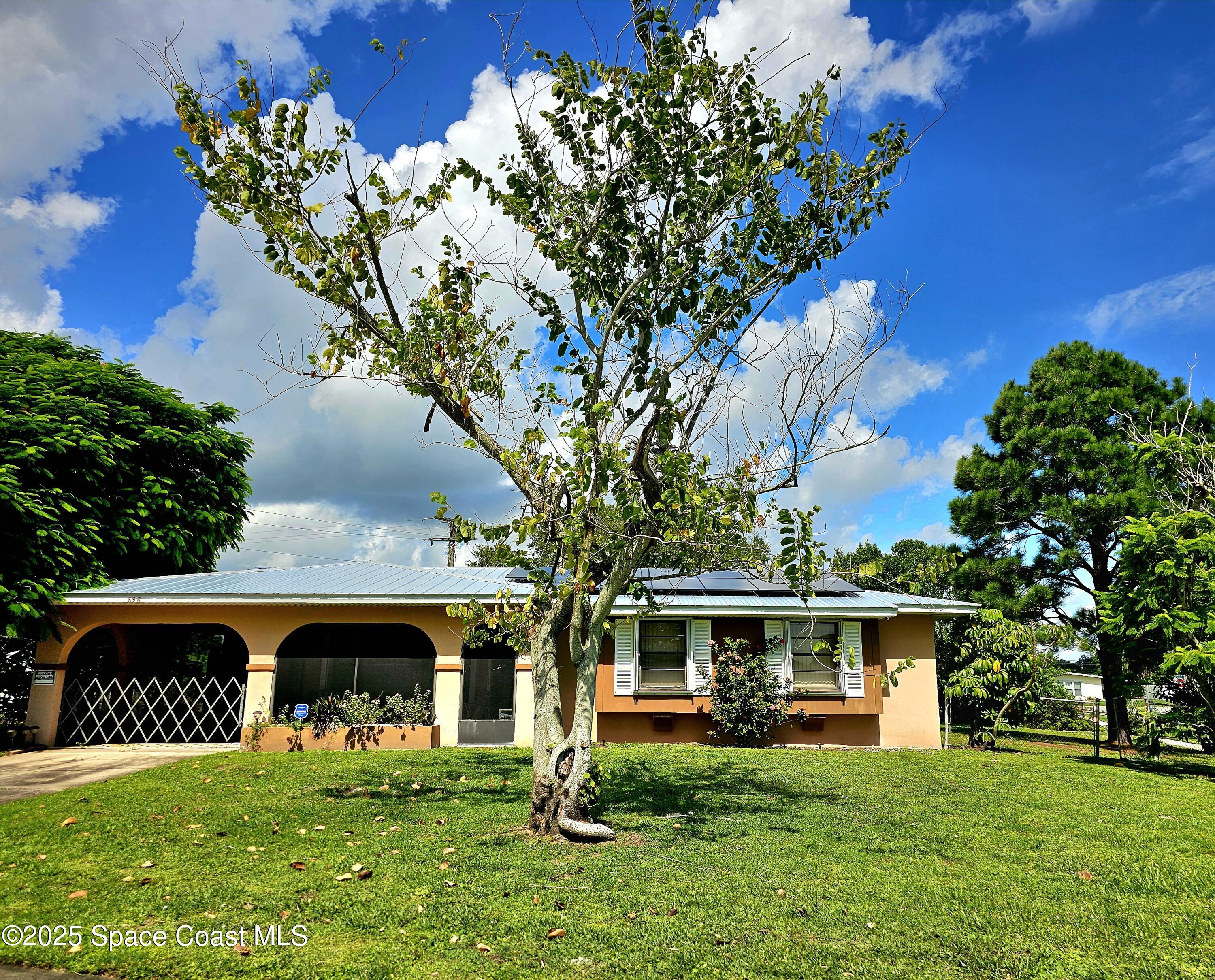 898 Hampton Drive Northeast Palm Bay, FL 32905 - Photo 2 of 20 a view of a house with a yard