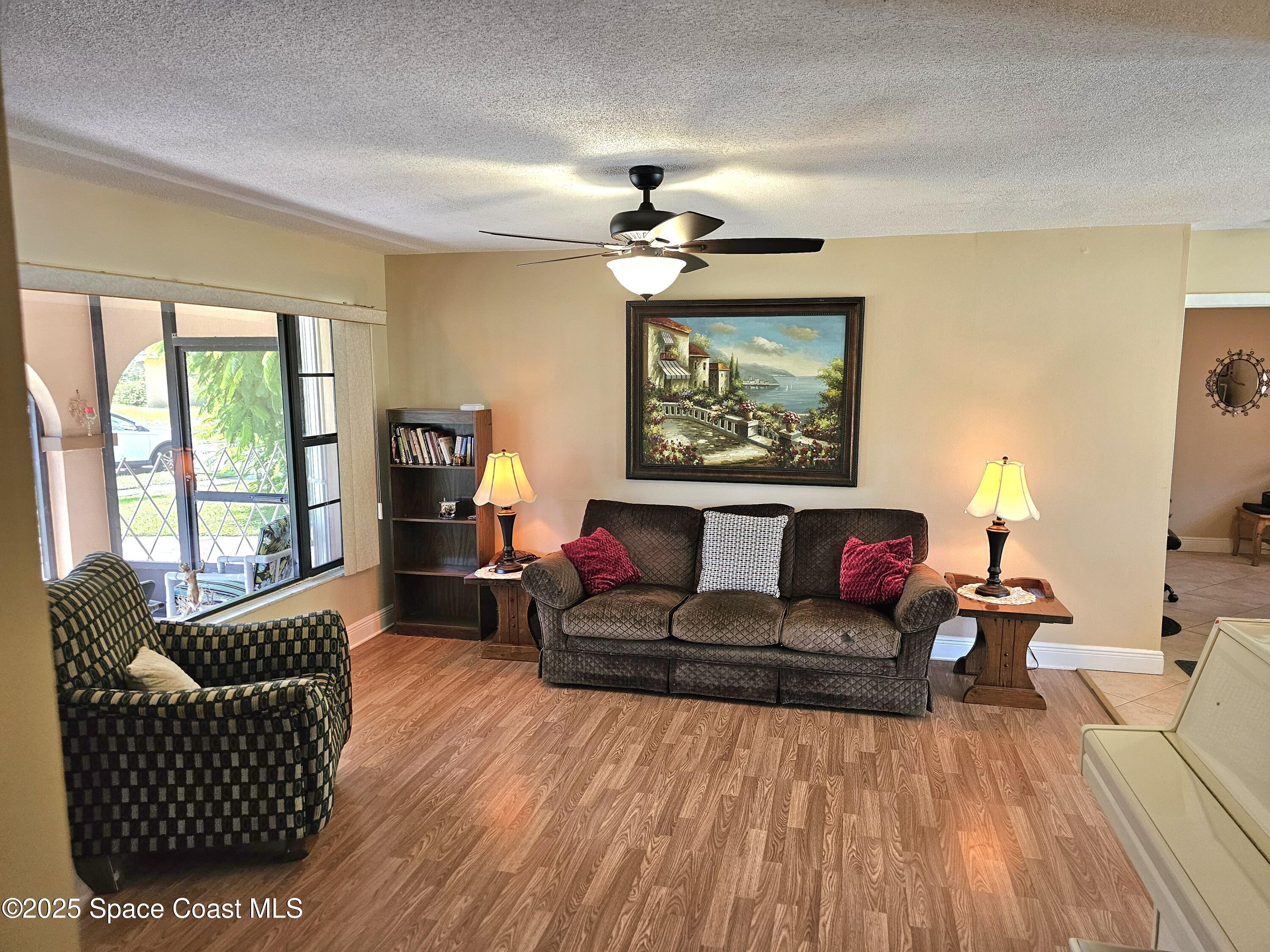 898 Hampton Drive Northeast Palm Bay, FL 32905 - Photo 6 of 20 a living room with furniture and a flat screen tv