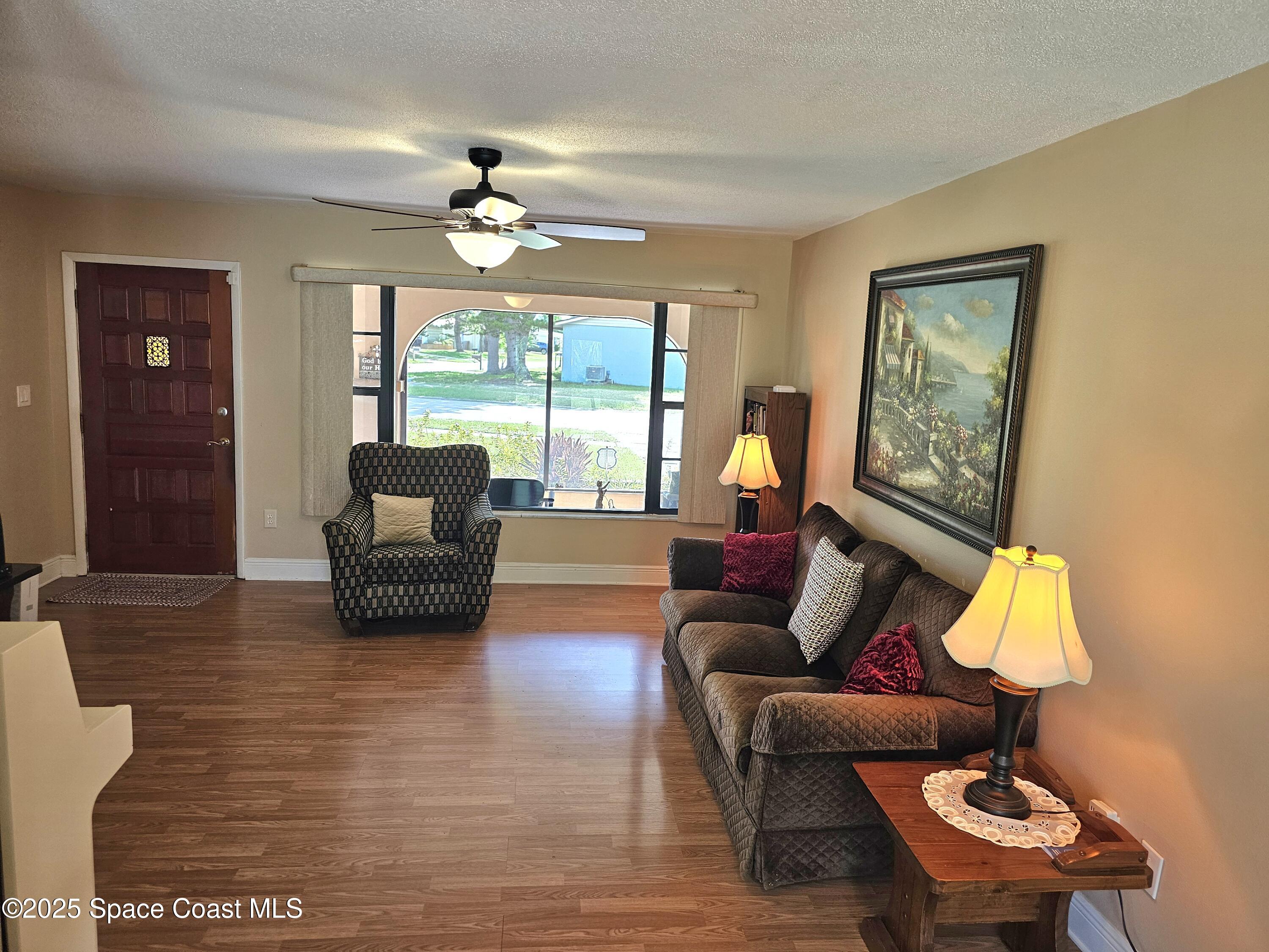 898 Hampton Drive Northeast Palm Bay, FL 32905 - Photo 7 of 20 a living room with furniture and a large window