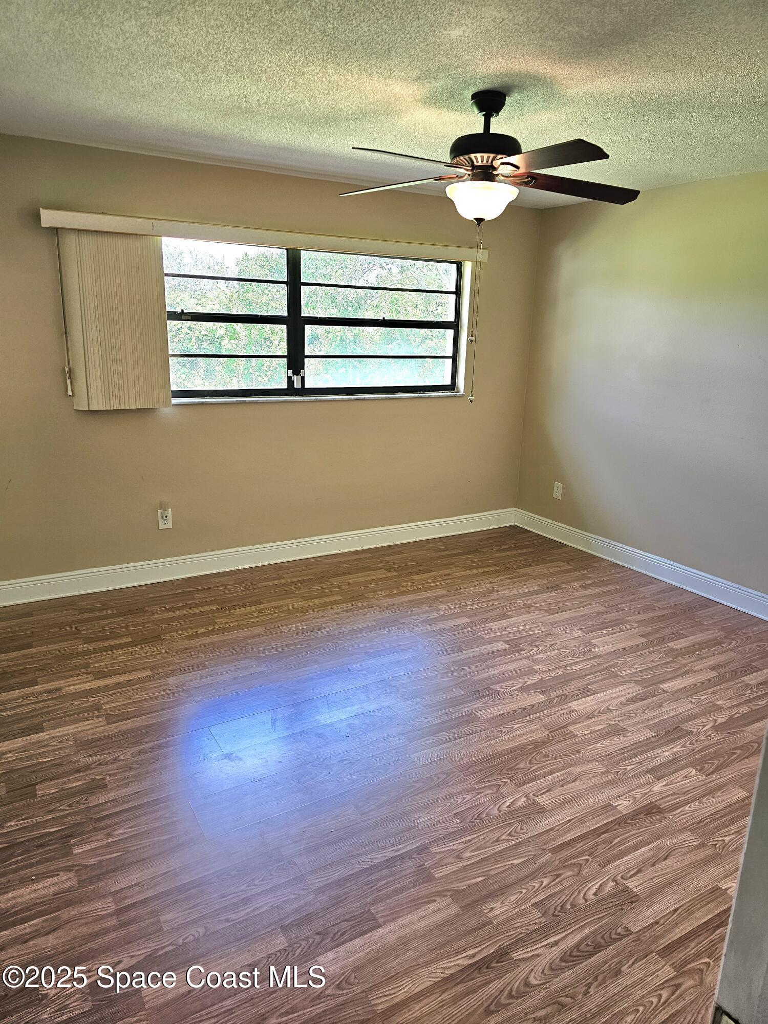898 Hampton Drive Northeast Palm Bay, FL 32905 - Photo 8 of 20 a view of a room with wooden floor