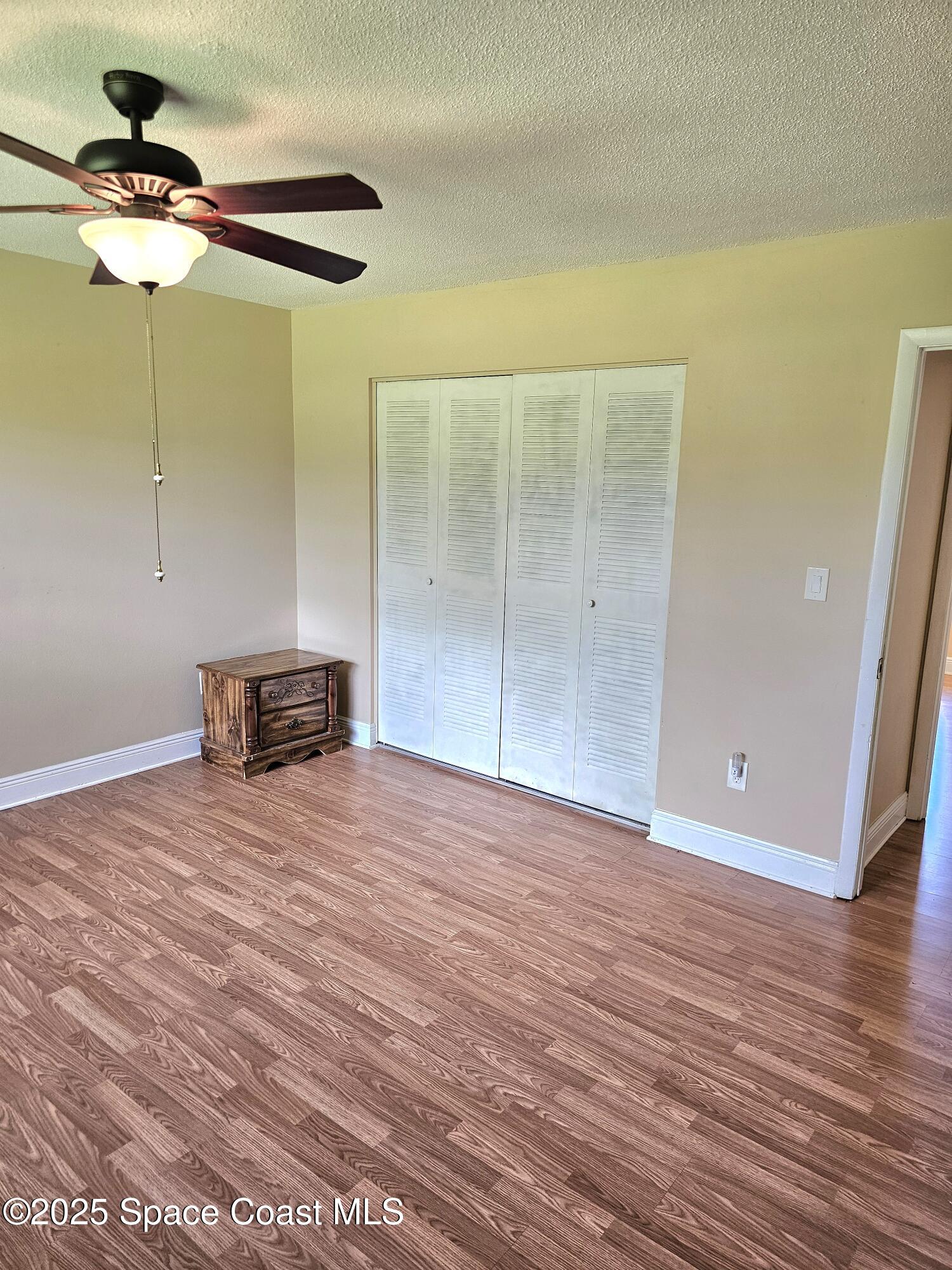 898 Hampton Drive Northeast Palm Bay, FL 32905 - Photo 9 of 20 a view of a room with wooden floor