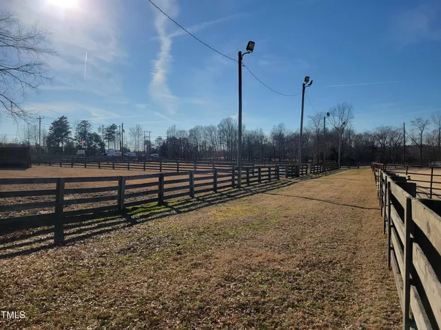 a front view of a house with basket ball court and a table
