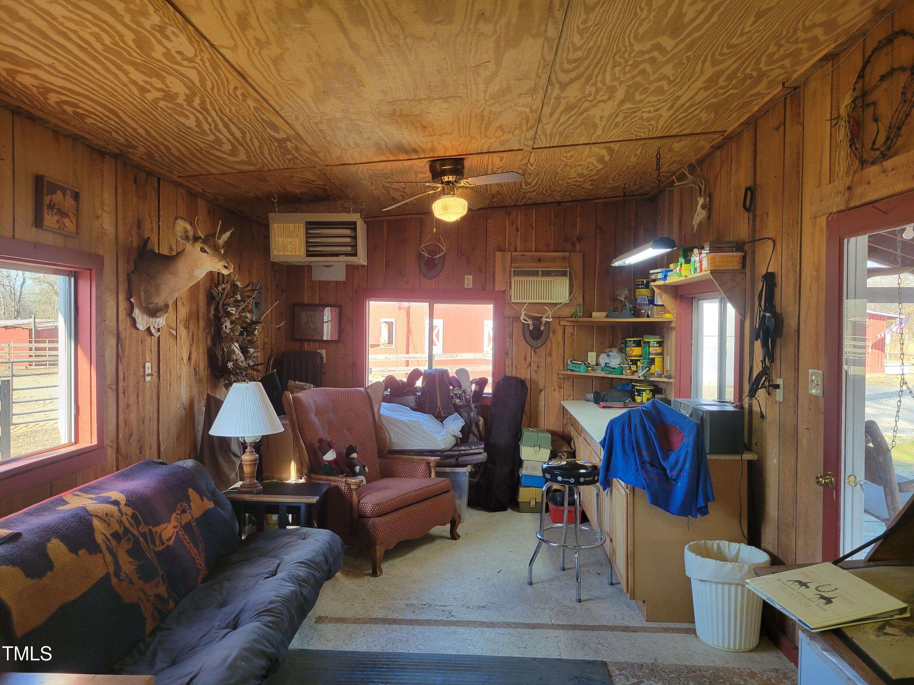 7027 Old 421 Road Julian, NC 27283 - Photo 40 of 72 a living room with furniture a window and a chandelier