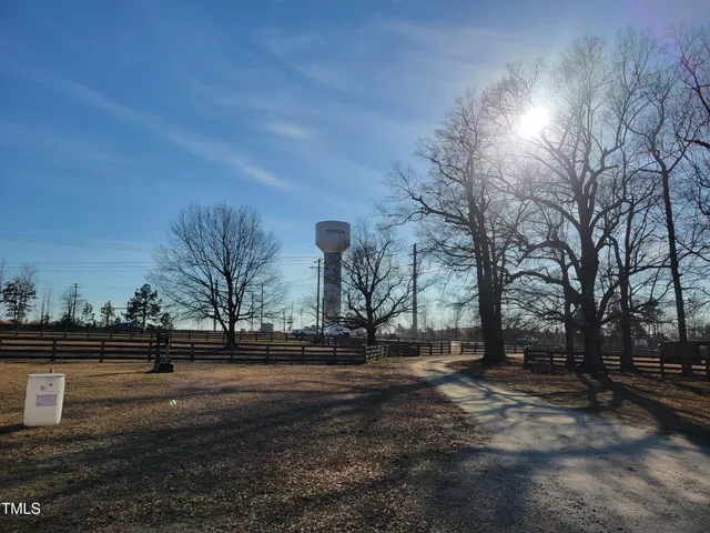 a living room with furniture gym equipment and a window