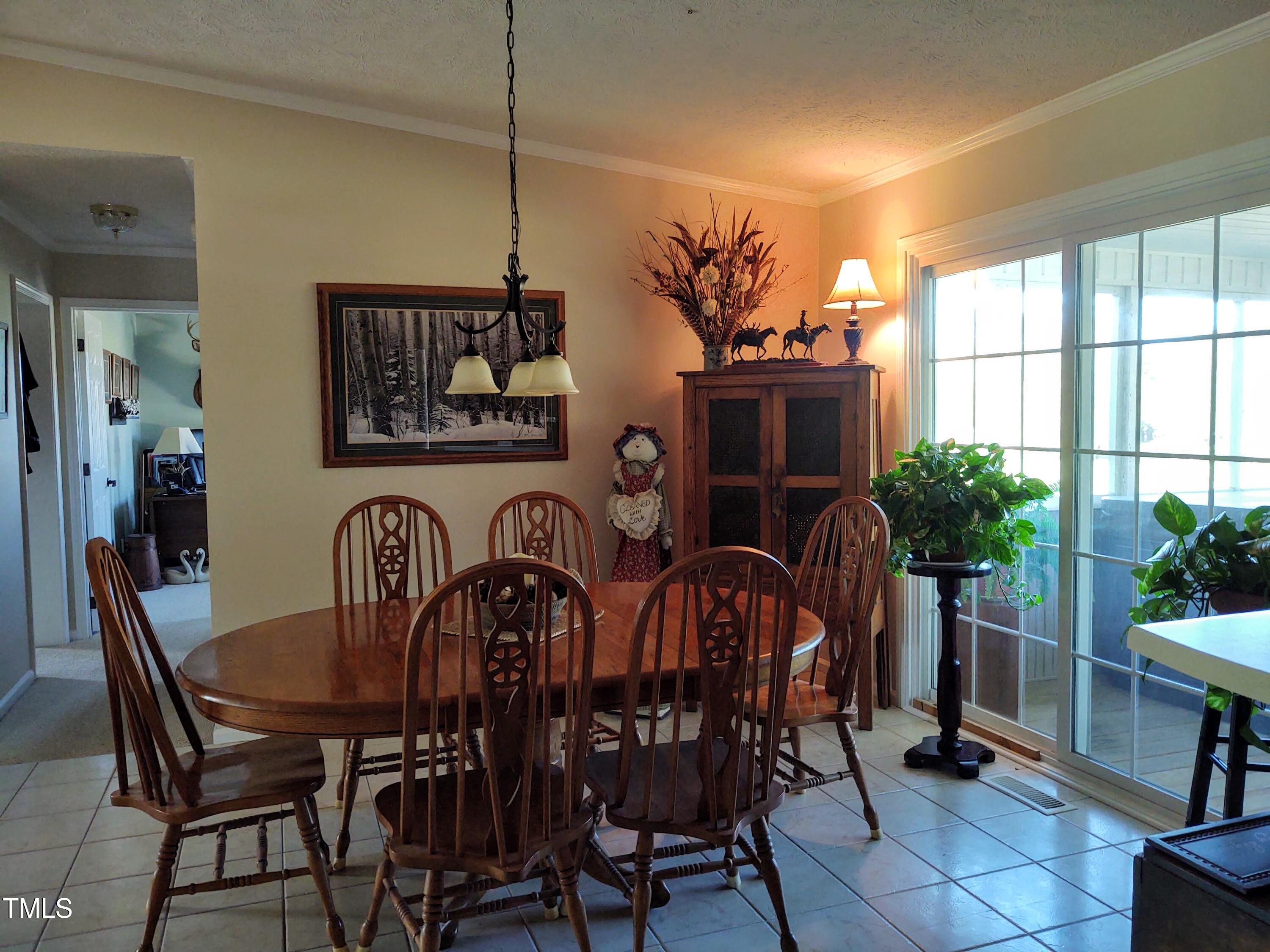 7027 Old 421 Road Julian, NC 27283 - Photo 49 of 72 a view of a dining room with furniture window and outside view