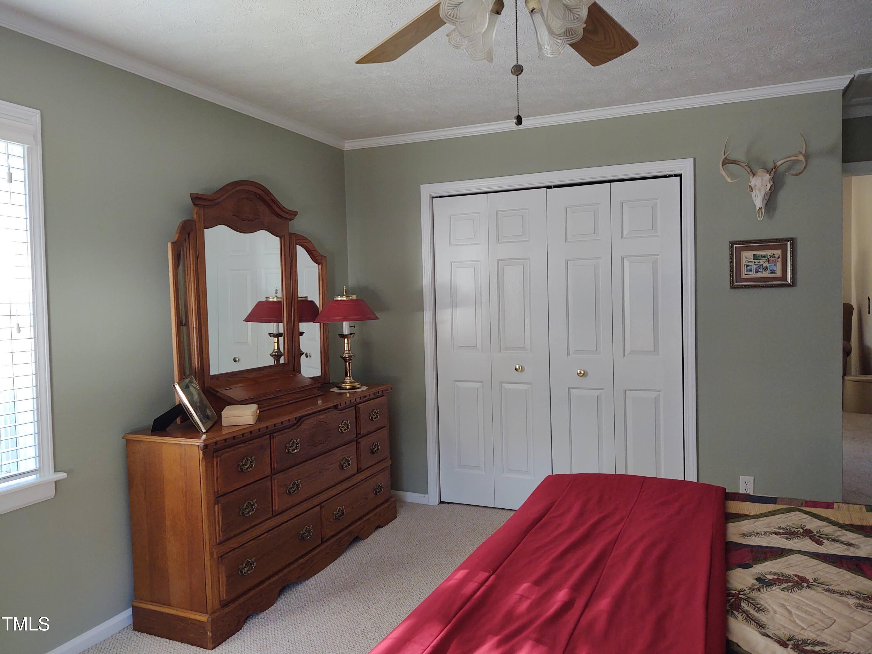 7027 Old 421 Road Julian, NC 27283 - Photo 52 of 72 a bedroom with a bed and wooden floor