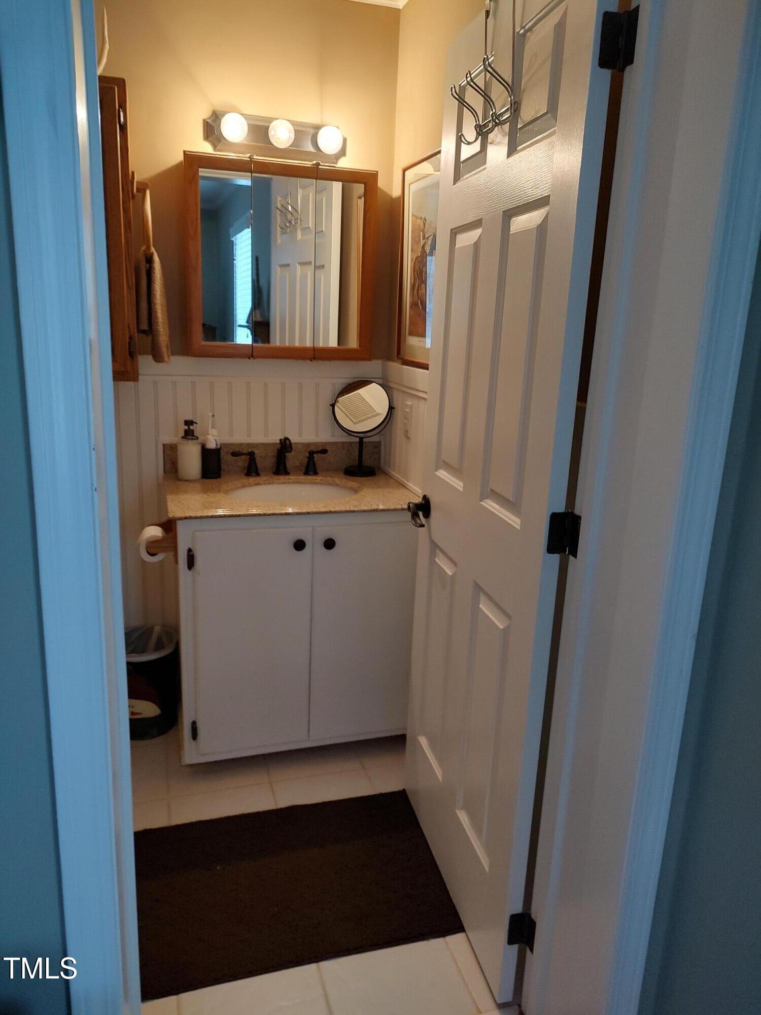 7027 Old 421 Road Julian, NC 27283 - Photo 58 of 72 a bathroom with a sink a mirror a vanity and a shower