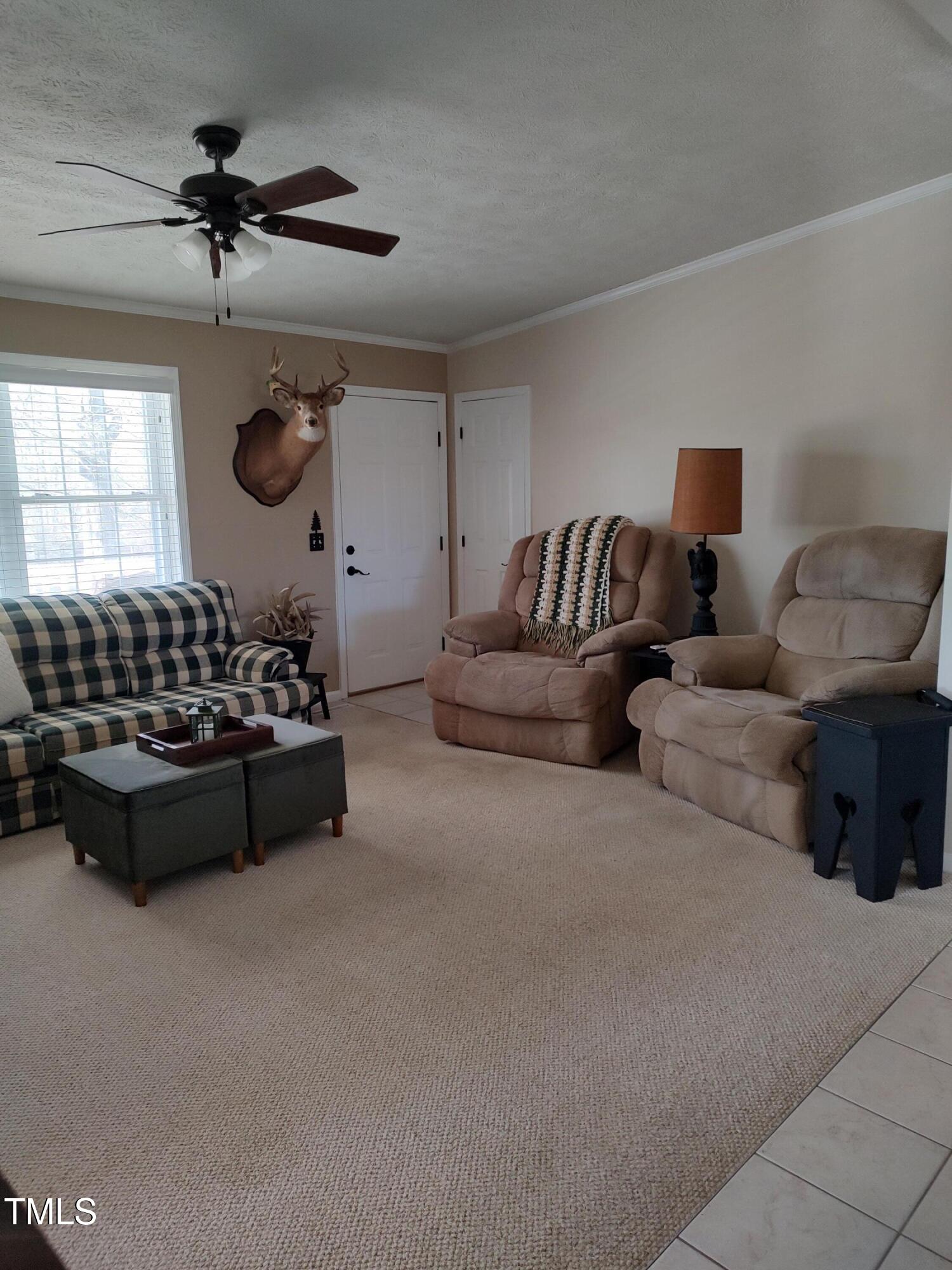 7027 Old 421 Road Julian, NC 27283 - Photo 60 of 72 a living room with furniture gym equipment and a window
