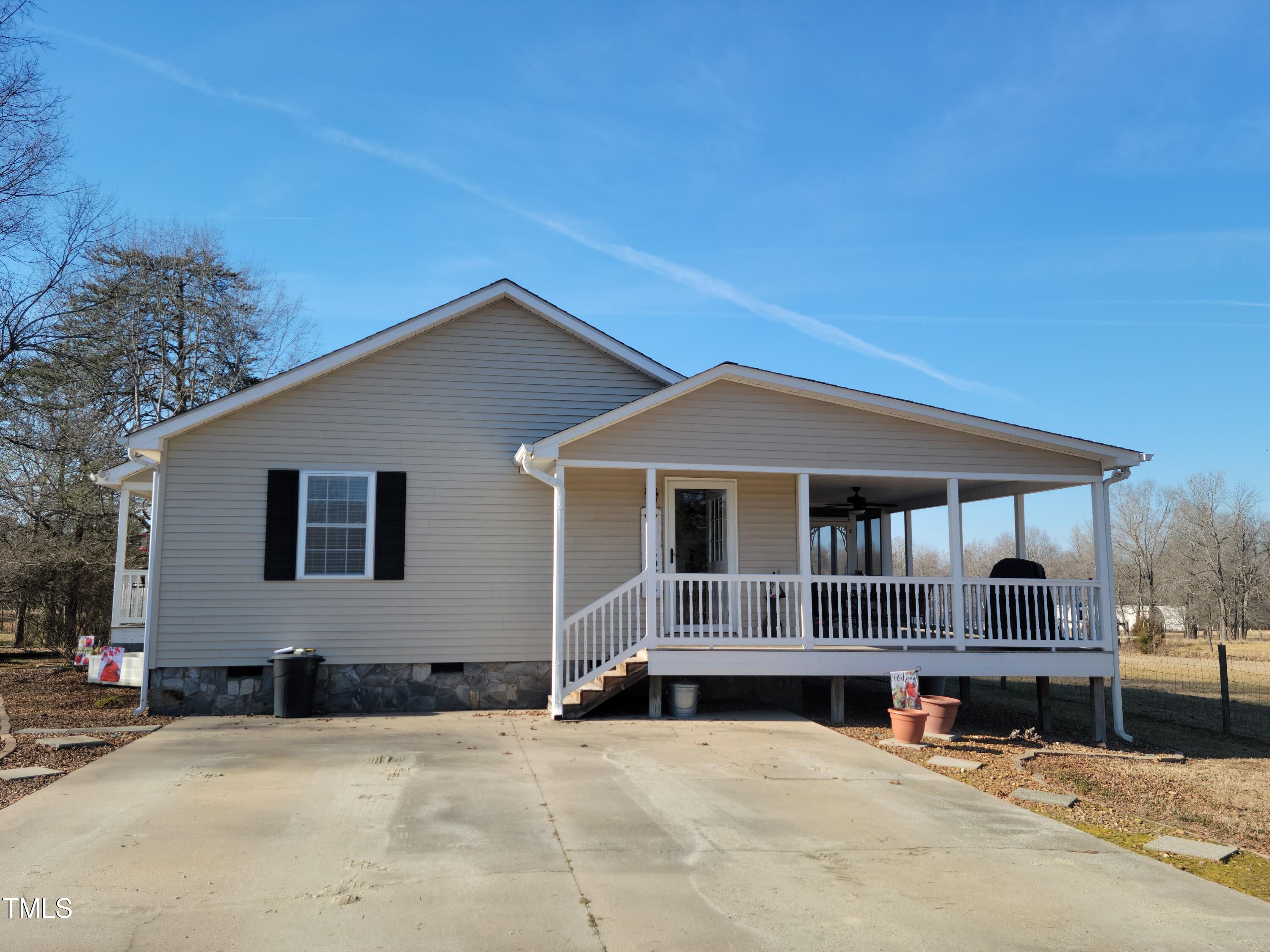 7027 Old 421 Road Julian, NC 27283 - Photo 10 of 72 a front view of a house with a yard