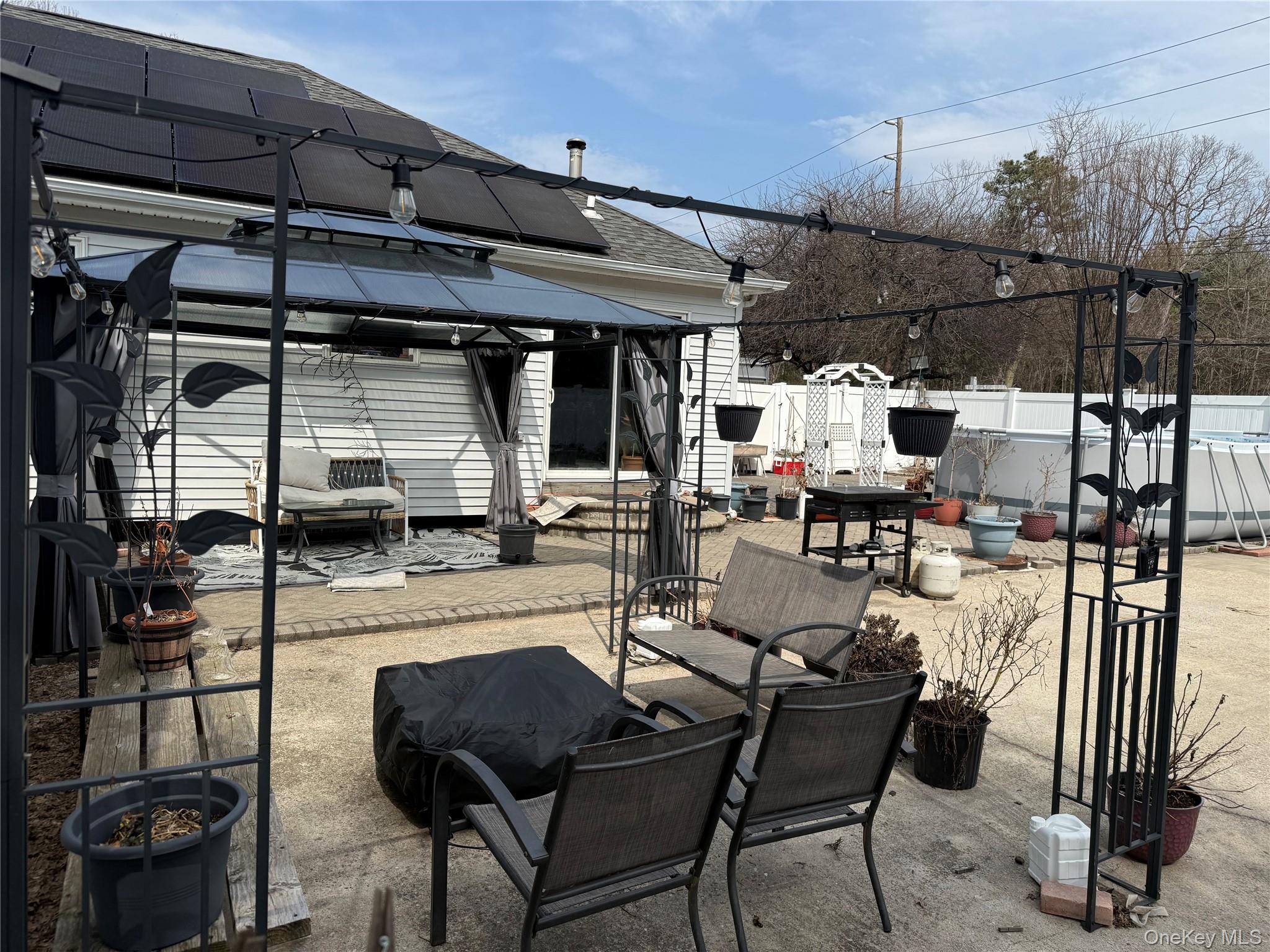 2 1st Street Coram, NY 11727 - Photo 12 of 36 a view of a patio with dining table and chairs under an umbrella