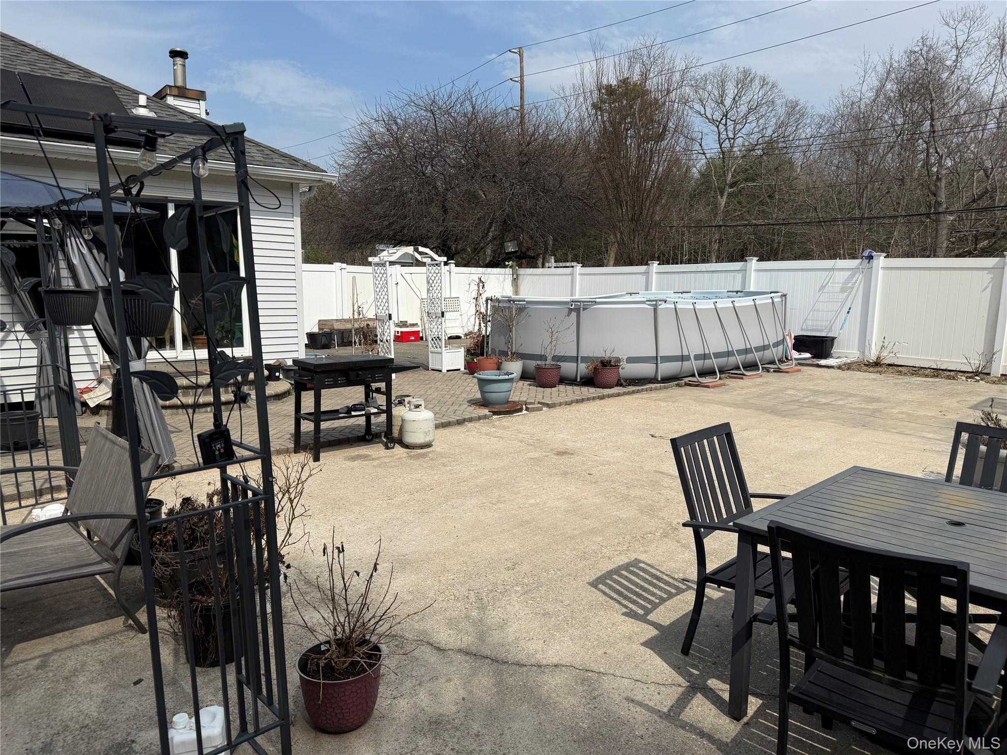 2 1st Street Coram, NY 11727 - Photo 13 of 36 a view of a patio with table and chairs with wooden floor and fence