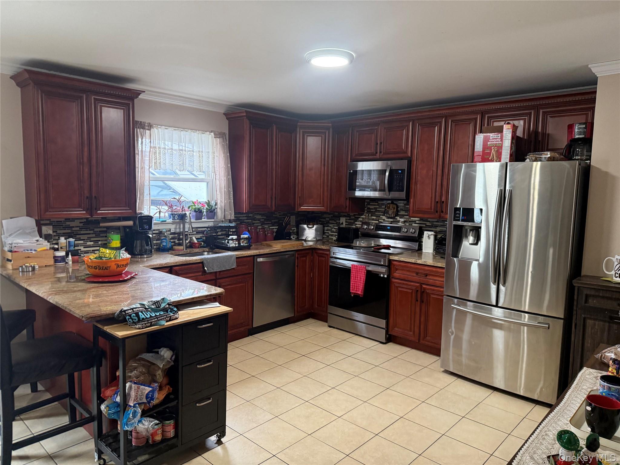2 1st Street Coram, NY 11727 - Photo 17 of 36 a kitchen with a refrigerator sink and cabinets