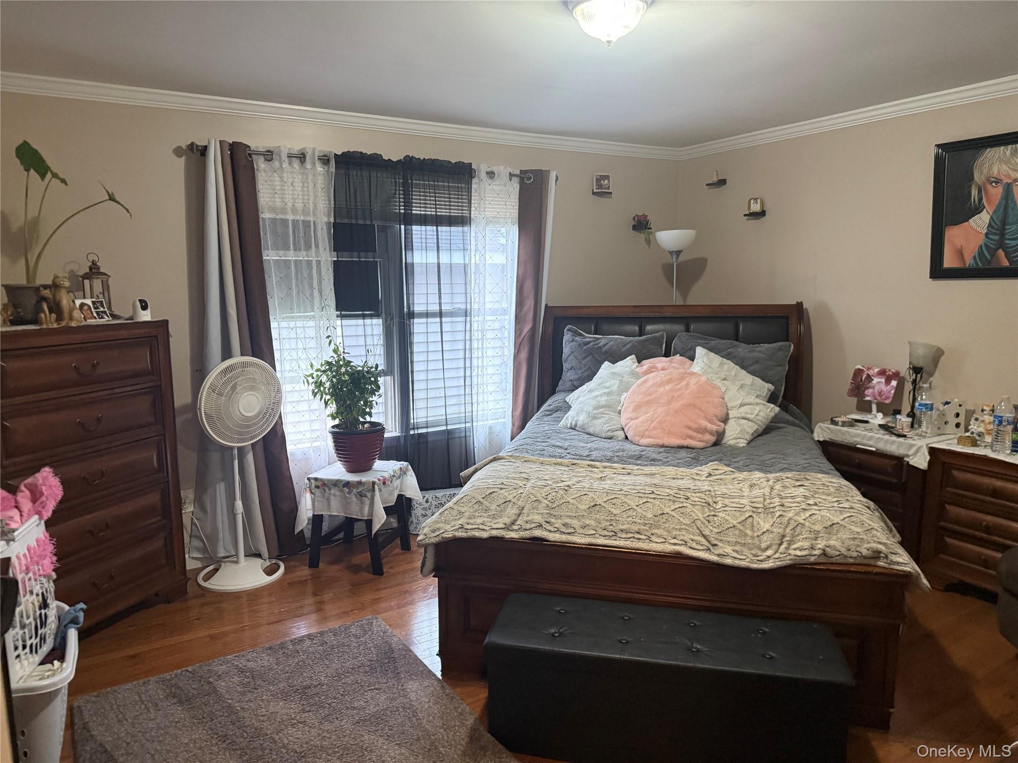 2 1st Street Coram, NY 11727 - Photo 25 of 36 a bedroom with a bed and dresser with wooden floor