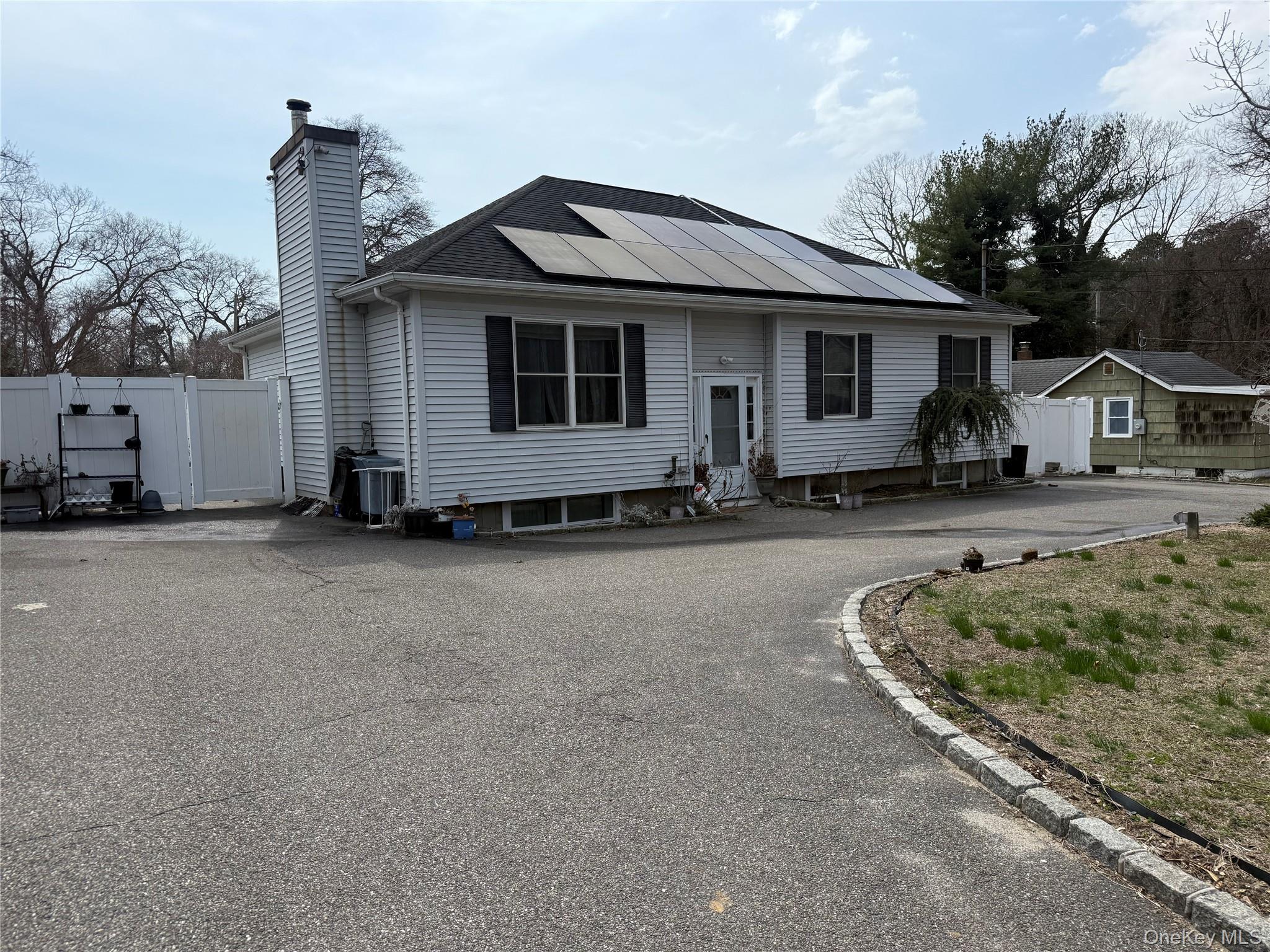 2 1st Street Coram, NY 11727 - Photo 6 of 36 a front view of a house with a yard